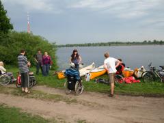 Dalībnieki ar laivām pulcējas Daugavas krastā